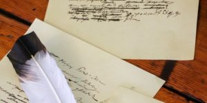 handwritten manuscript pages with feather quill
